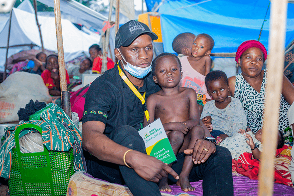 Family standing in front of their rehabilitated home